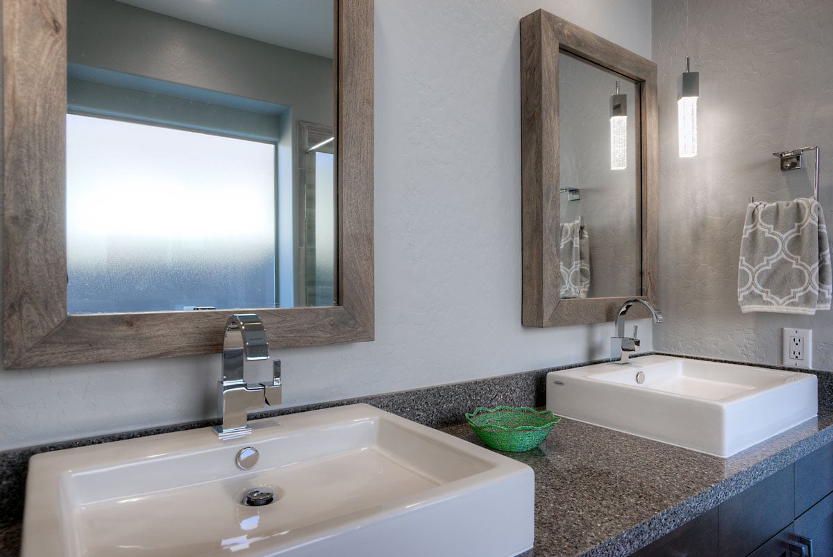 Transitional bathroom with double vanity sinks and mirrors