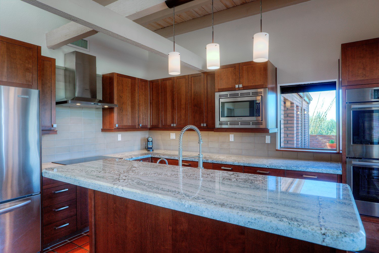 Kitchen island with granite countertops and stainless steel appliances