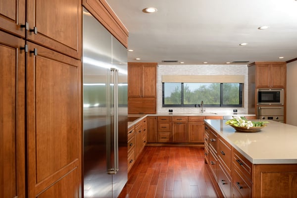 Contemporary kitchen remodel with cherry hardwood flooring and a white quartz countertop