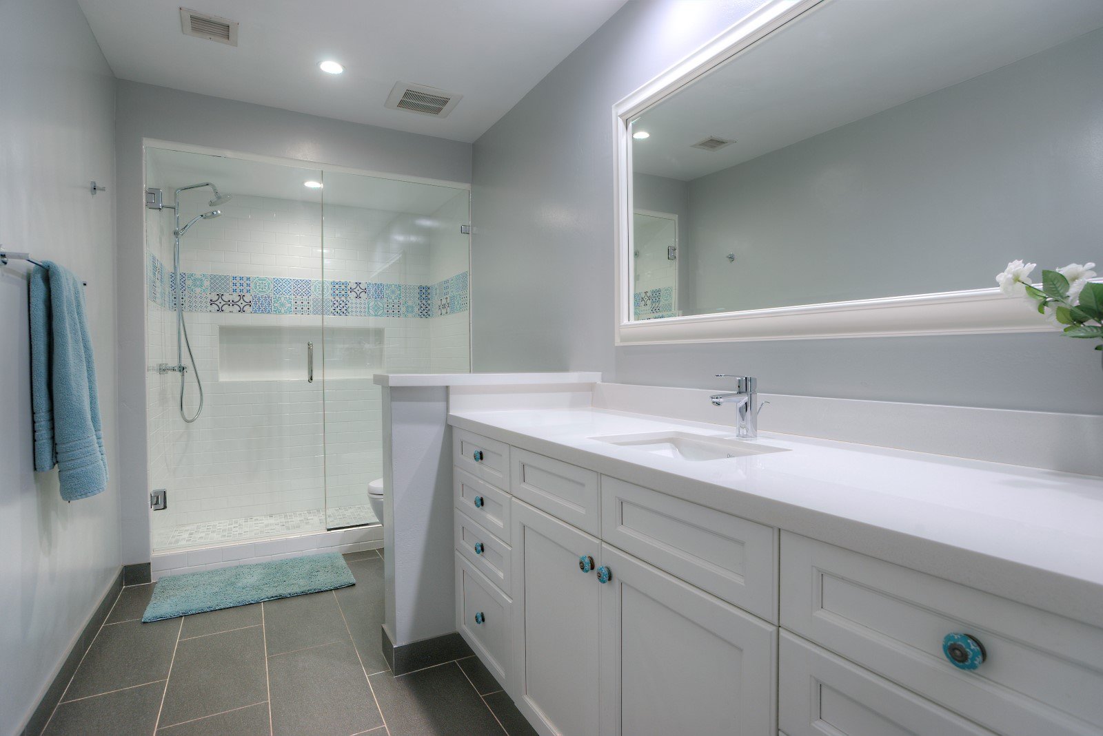 Bathroom with single vanity and a walk in shower