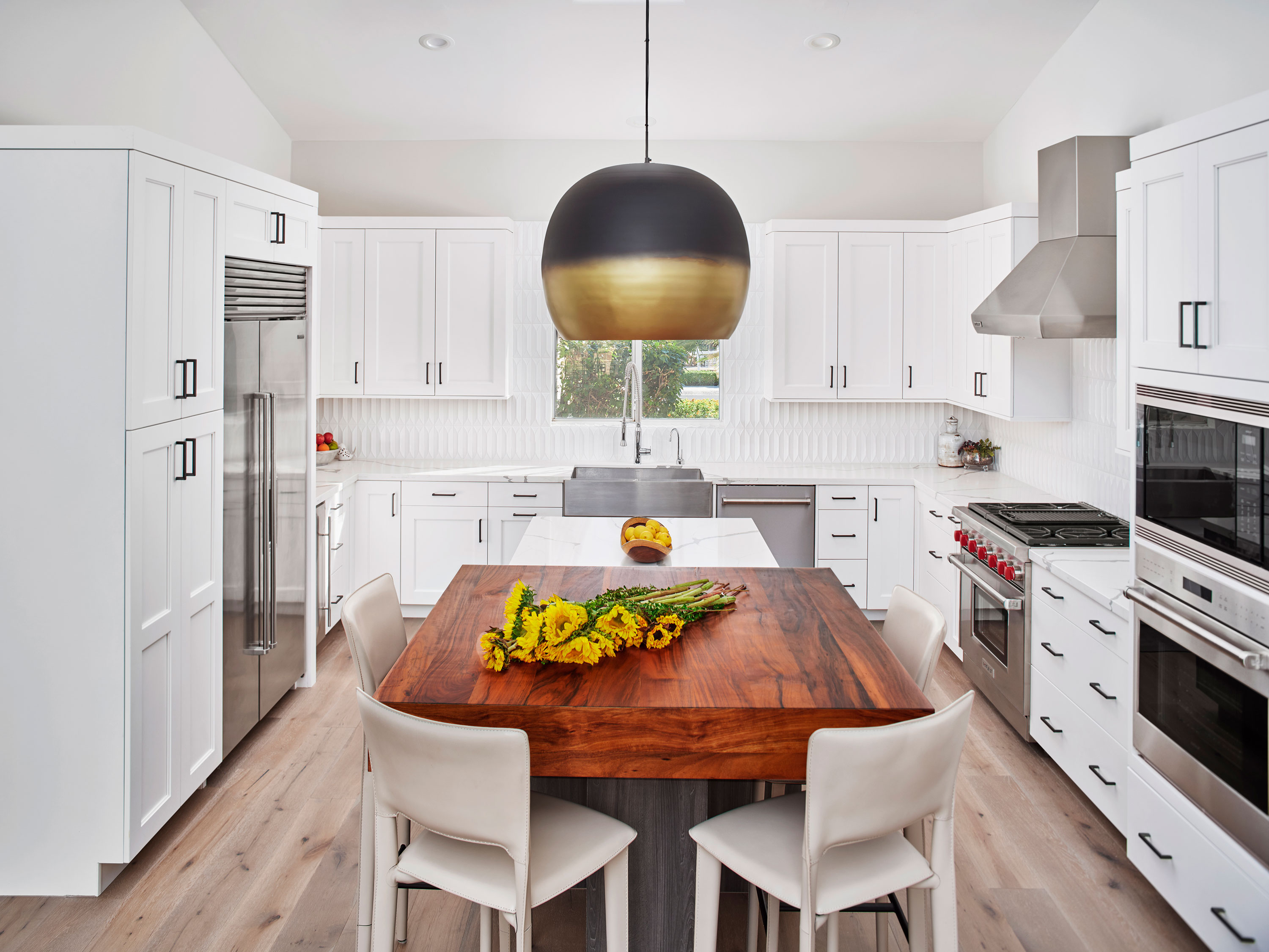 Kitchen and dining room featuring white chairs and cabinets