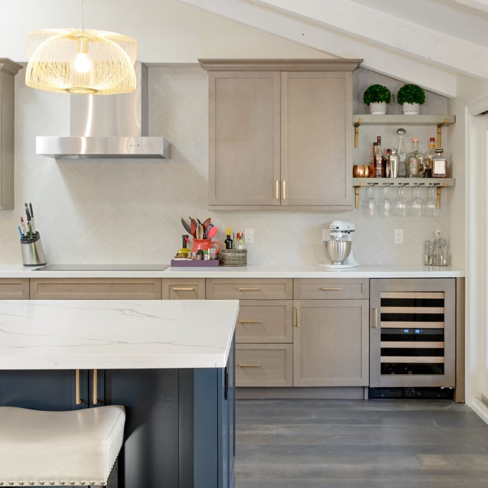 Kitchen with beige cabinets and marble island countertop