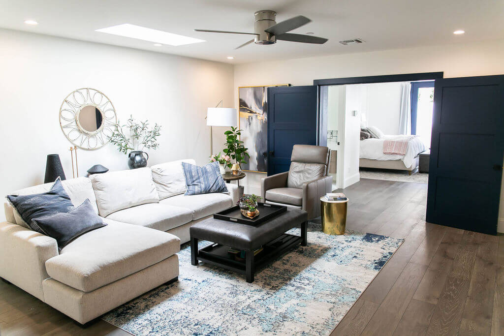 Family room with a white sectional couch and coffee table